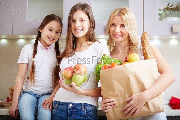 Three females posing with products in the kitchen