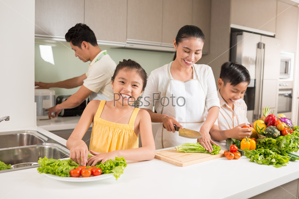 Happy Vietnamese family cooking dinner together