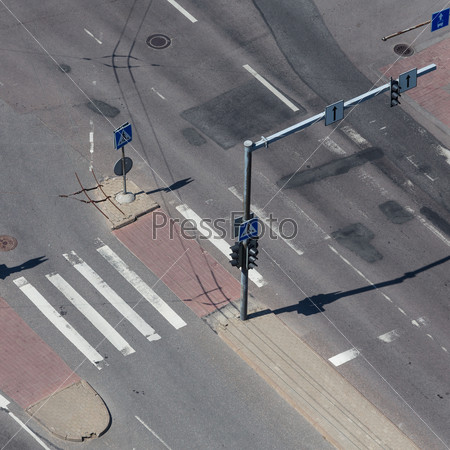 high angle view of an empty street intersection with cross walk markings, traffic signal lights