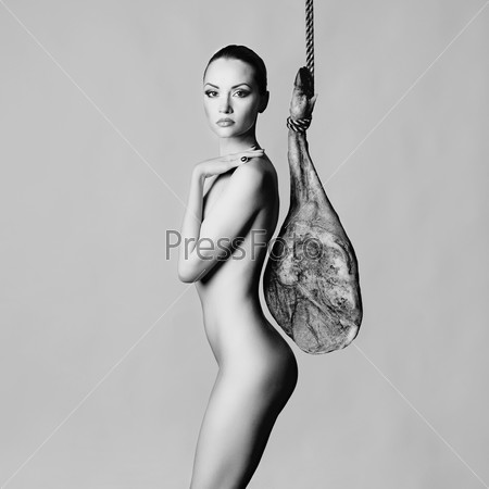 Stylish art photo of nude elegant woman with Iberian jamon