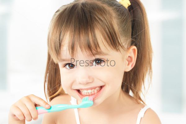 Счастливая девочка чистит зубы