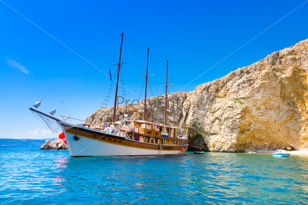 Vintage sailing boat anchored in an idyllic bay on Krk island in Croatia in Mediterranean sea.