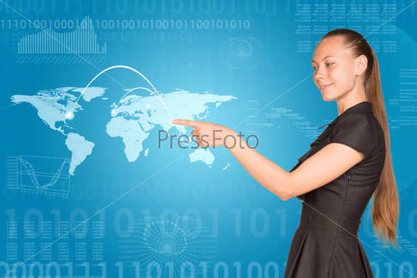 Beautiful businesswoman in dress presses finger virtual map of world