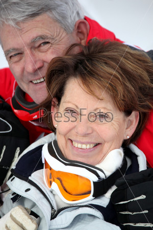 Elderly couple skiing