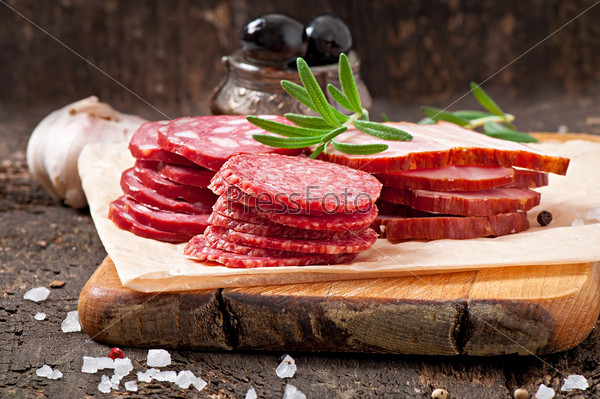 Assorted deli meats, rosemary and pepper, stock photo