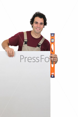 Handyman with poster and spirit-level