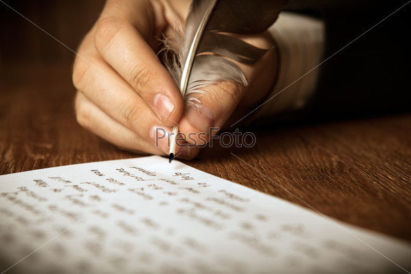 writer writes a fountain pen on paper work close up