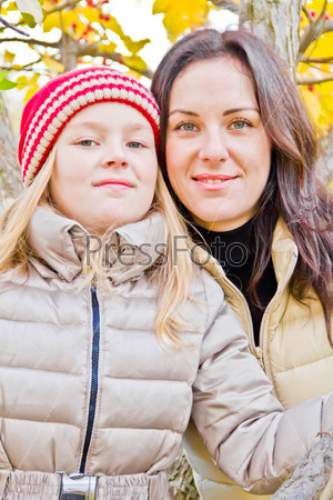 Mother and daughter in autumn