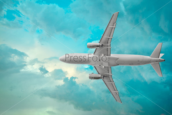 Passenger airplane on the beautiful cumulus clouds background