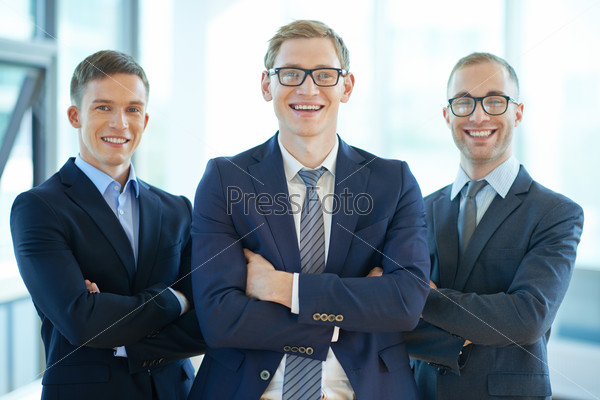 Three confident business workers smiling at camera, stock photo