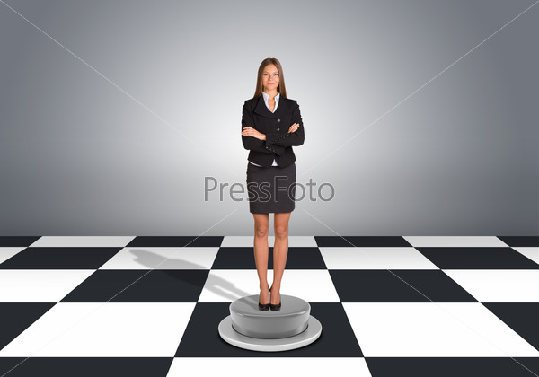 Beautiful businesswoman standing with crossed arms. Floor with checkerboard texture and gray wall
