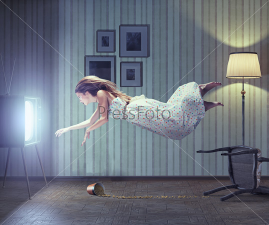 Young beautiful woman flying to tv screen in vintage interior. Creative concept