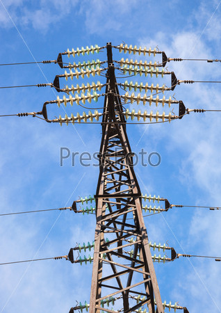High voltage electric tower against blue sky