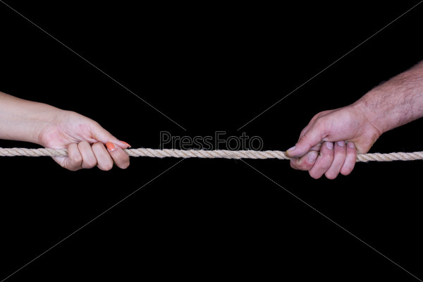 Female and male hands pulling rope