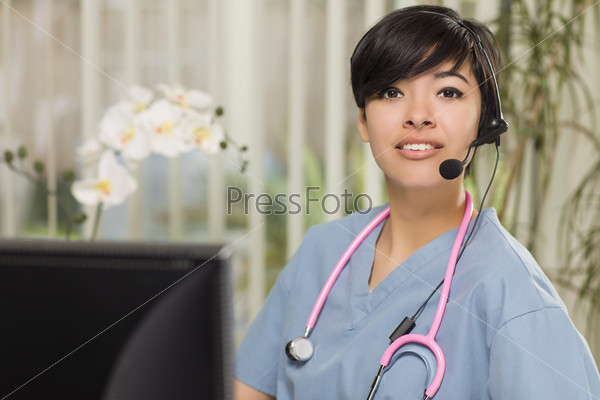 Mixed Race Female Nurse Practitioner or Doctor at Computer