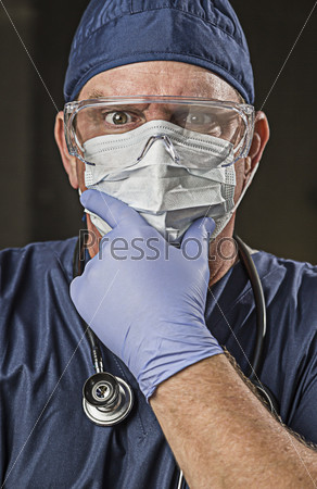 Determined Looking Male Doctor or Nurse with Protective Wear\
and Stethoscope.