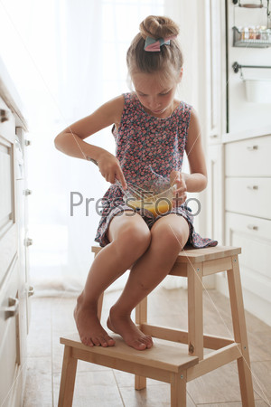 7 years old school girl cooking on the vintage kitchen, casual lifestyle photo series