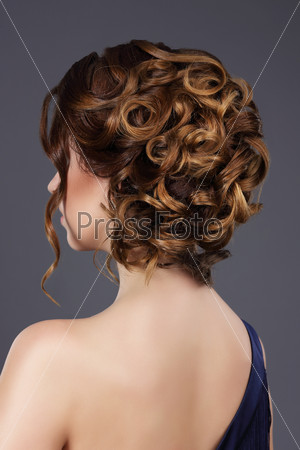 Rear View of Woman\'s Festive Hairstyle. Waved Hairs