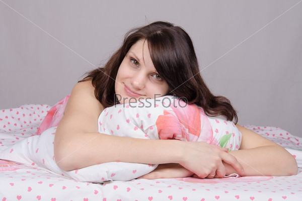 Beautiful young girl lying in the bed