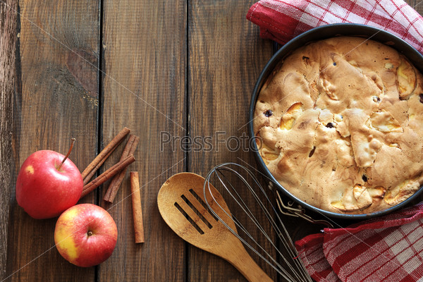 Closeup photo of holiday apple pie on rustic wooden background, top view point