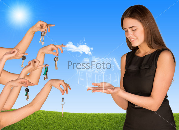Beautiful smiling girl holding house from the air. Many hands are given keys. Grass and sky in background, stock photo