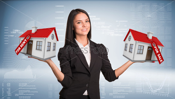 Businesswoman holding housees in hands