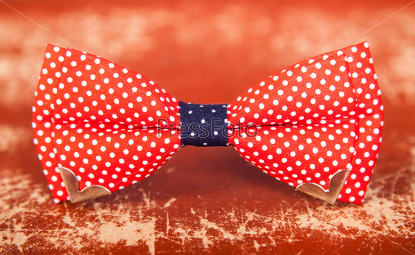 red bow tie with white polka dots