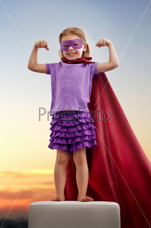 a little girl plays superhero