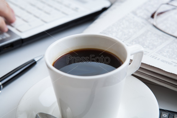 businessman running and a cup of coffee on him desktop