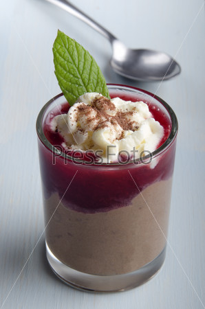 chocolate mascarpone dessert with strawberry mousse, whipped cream, cocoa powder and mint  in a shot glass