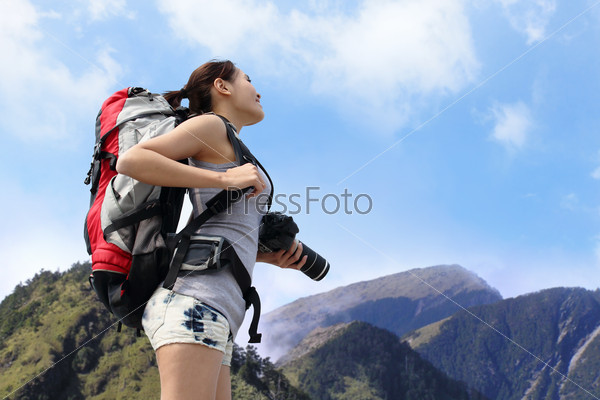 happy woman mountain hiker with backpack and looking to sky on the top of mountains. asian