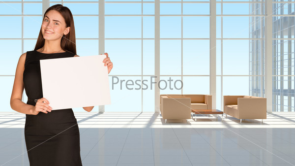 Businesswoman holding empty paper. Large window in office building as background