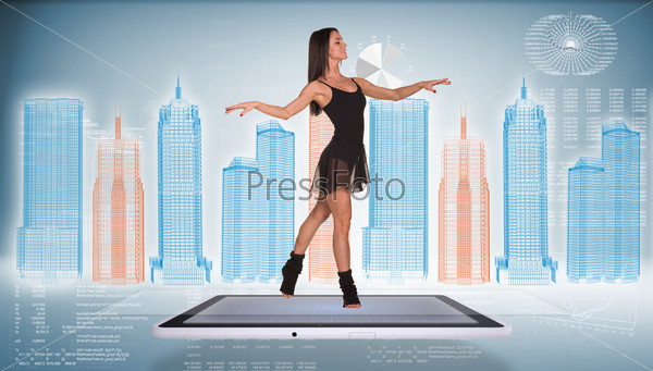 Beautiful woman dancer dancing on screen of tablet pc. Wire-frame business city and graphs as backdrop, stock photo