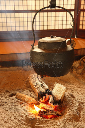 warm Japan teapot with fire in  japanese-style living room