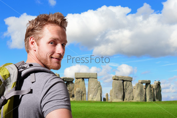 Young man travel in stonehenge, an ancient prehistoric stone monument near Salisbury, Wiltshire, UK. in England. caucasian