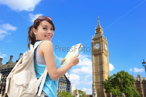 Happy woman travel in London with Big Ben tower, she look map and smile to you, asian