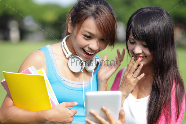 Girl students using tablet pc