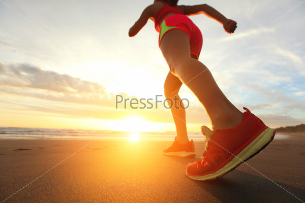 Woman Runner feet running on the beach at sunrise closeup on shoe. woman fitness sunrise jog workout welness concept. asian