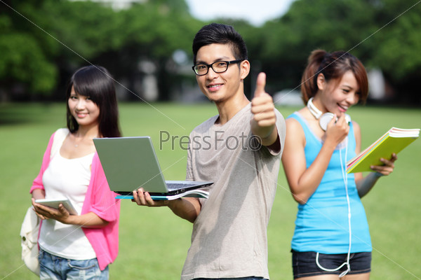 Happy College student man smile and show thumb up to you on campus lawn, asian