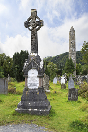 Wicklow, Ireland - August 21, 2014: Medieval Celtic cemetery and a round tower in Wicklow Mountains National Park