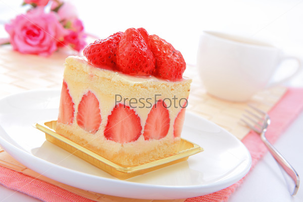 Dessert - sweet cake with strawberry on a plate with rose background