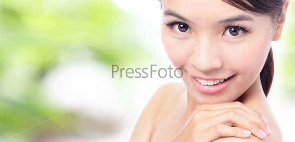 close up of Beauty woman Face and hand touch shoulder with green background for skin care concept, model is a beautiful asian girl