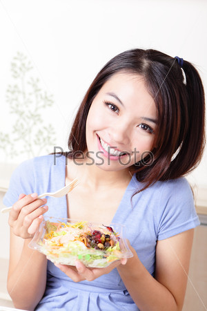 Young Girl Happy Eat salad at home, model is a asian beauty