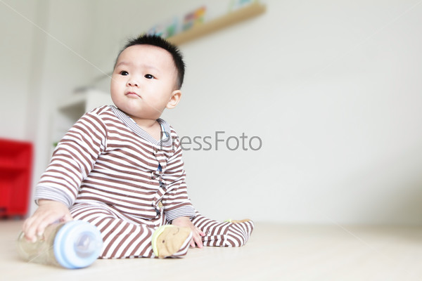 Cute Baby look left and take his feeding bottle