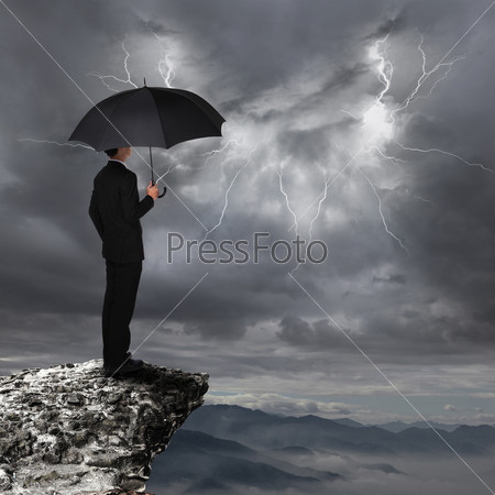 Business Man with umbrella look rainstorm cloud