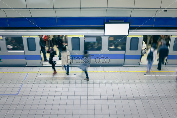 moving people enter carriage at a metro railway station with blank tv billboard, shot in Taipei, Taiwan, asia
