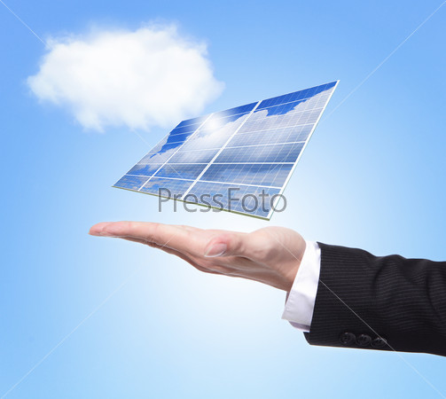 eco concept - Business man hold Alternative Energy (solar cell ) with blue sky and cloud background