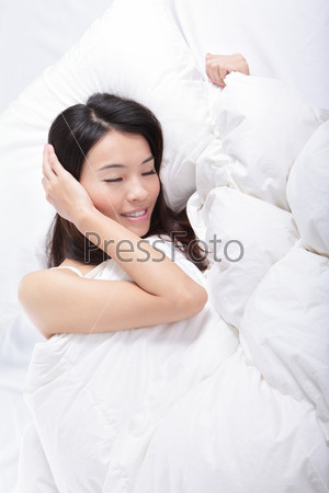 young woman sleep on bed at home in the morning (from high angle view), model is a asian girl