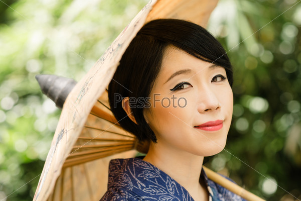 Portrait of pretty Japanese girl with parasol