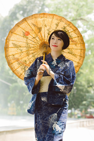 Smiling Japanese girl wearing blue yukata dress